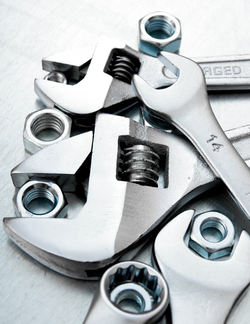 Auto technician polishing a car hood inside a workshop