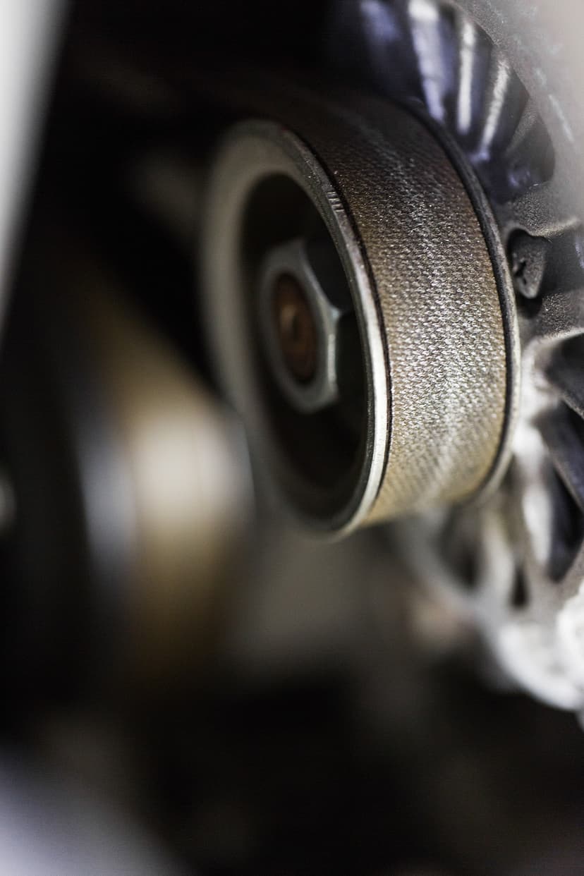 Close-up of timing belt tensioner pulley during cambelt service at Cool Cars, Hampshire