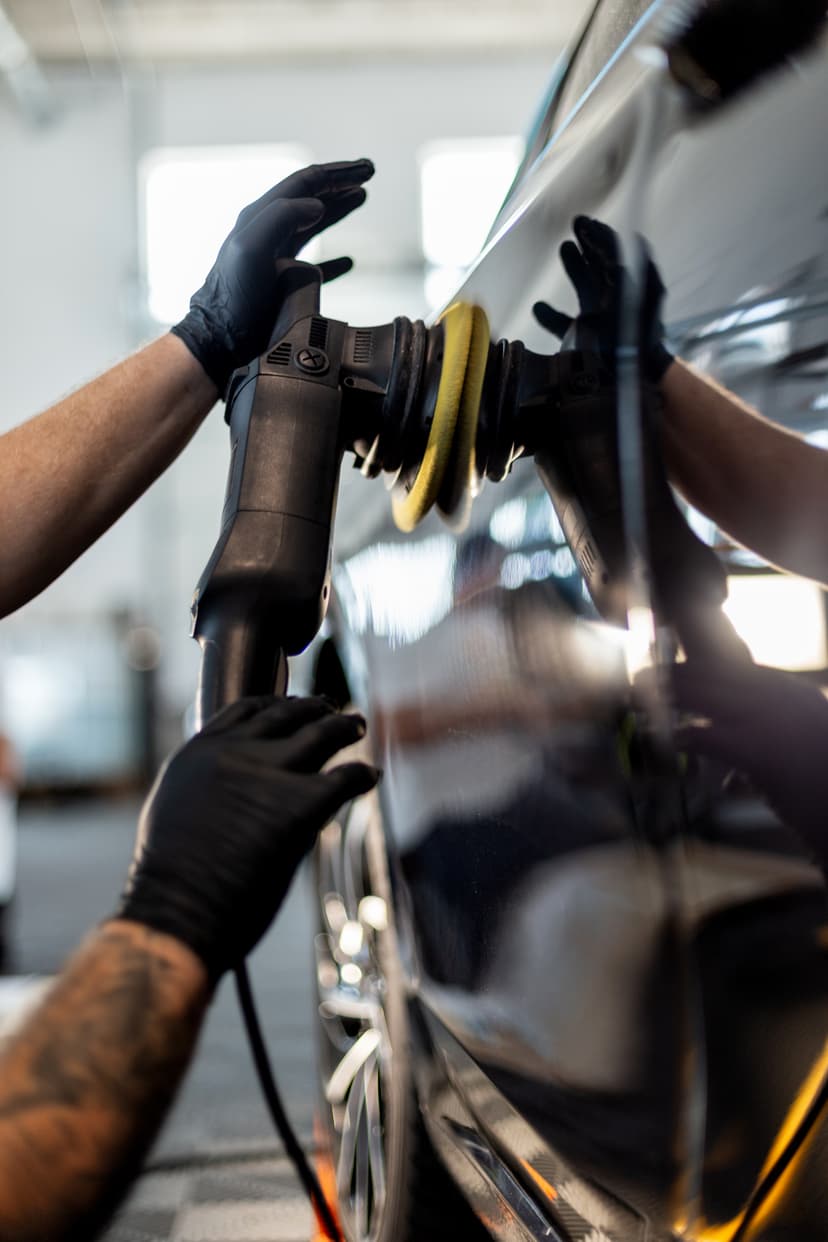 Detailer applying dual-action machine polish to dark car at Cool Cars, Swanmore, Hampshire